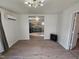 Spacious living room with wood floors, modern light fixture, and mini split air conditioner at 611 Rowland St, Henderson, NC 27536
