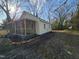 Charming house featuring a full-property length yard and convenient access to the screened-in porch at 611 Rowland St, Henderson, NC 27536