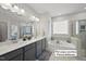 Luxurious bathroom with double vanity, soaking tub, and separate glass shower at 612 Sweet Pine Ln, Knightdale, NC 27545