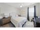 Cozy bedroom features neutral walls, ceiling fan, and a comfortable bed at 612 Sweet Pine Ln, Knightdale, NC 27545