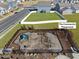Aerial view of the community playground with play equipment, fenced perimeter, and landscaping at 612 Sweet Pine Ln, Knightdale, NC 27545