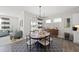 Cozy dining area with a stylish chandelier, seating for six, and access to outdoor living space at 612 Sweet Pine Ln, Knightdale, NC 27545