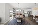 Charming dining area featuring a modern chandelier, seating for six, and easy access to the kitchen and patio at 612 Sweet Pine Ln, Knightdale, NC 27545