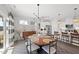 Open dining area with a modern chandelier, seating for six, and easy access to the kitchen and patio at 612 Sweet Pine Ln, Knightdale, NC 27545