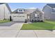 Charming single-Gathering home featuring stone accents, a two-car garage, and a well-manicured lawn at 612 Sweet Pine Ln, Knightdale, NC 27545