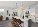 Bright kitchen with white cabinets, stainless steel appliances, and a large island with bar seating at 612 Sweet Pine Ln, Knightdale, NC 27545