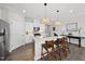 Spacious kitchen featuring stainless steel appliances, an island with seating, and pendant lights at 612 Sweet Pine Ln, Knightdale, NC 27545