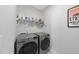 Modern laundry room featuring a front-load washer and dryer at 612 Sweet Pine Ln, Knightdale, NC 27545