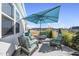 Outdoor patio with modern furniture, including a table, chairs, and a large blue umbrella at 612 Sweet Pine Ln, Knightdale, NC 27545