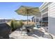 Backyard patio features an outdoor dining area, a large umbrella, and a view of the neighborhood at 612 Sweet Pine Ln, Knightdale, NC 27545
