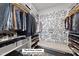 Spacious walk-in closet with custom shelving, modern storage solutions, and bench at 612 Sweet Pine Ln, Knightdale, NC 27545