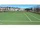 Green tennis court with white lines and new homes in background at 621 Leland Hl Cir, Zebulon, NC 27597