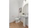 A modern half bathroom featuring a pedestal sink, modern fixtures, and hardwood floors at 640 Gainer Dr # 21, Raleigh, NC 27610