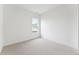 Bright bedroom featuring a carpeted floor, white walls, and a window providing natural light at 640 Gainer Dr # 21, Raleigh, NC 27610