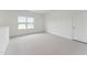 Bright carpeted bedroom with white walls and a window providing natural light at 640 Gainer Dr # 21, Raleigh, NC 27610