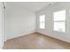 Bright bedroom features hardwood floors, two large windows, and ample natural light at 640 Gainer Dr # 21, Raleigh, NC 27610