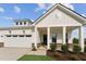 Beautiful home exterior with a well-manicured lawn, covered entrance, and attached garage at 640 Gainer Dr # 21, Raleigh, NC 27610