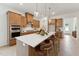 Stylish kitchen with a large island, pendant lighting, stainless steel oven, and wood cabinets at 640 Gainer Dr # 21, Raleigh, NC 27610
