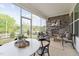 Inviting sunroom featuring a stone fireplace, comfortable seating, and a dining table with views at 640 Gainer Dr # 21, Raleigh, NC 27610