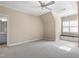 Spacious carpeted bedroom with window seat and adjoining bathroom at 10014 Hammock Bend Bnd, Chapel Hill, NC 27517
