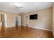 Bedroom features hardwood floors, television, and closet at 10014 Hammock Bend Bnd, Chapel Hill, NC 27517
