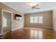 Bedroom with wood floors, a large window, and a mounted television at 10014 Hammock Bend Bnd, Chapel Hill, NC 27517