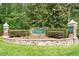 Stone entrance to Governors Forest boasts a manicured landscape and established trees, creating a welcoming ambiance at 10014 Hammock Bend Bnd, Chapel Hill, NC 27517