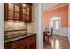 Dining room showcases elegant cherry cabinetry, granite countertops and a view into a sunlit dining area at 10014 Hammock Bend Bnd, Chapel Hill, NC 27517