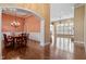 Open concept dining room featuring hardwood floors, chandelier, and arched entryways into adjacent living spaces at 10014 Hammock Bend Bnd, Chapel Hill, NC 27517