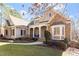 Beautiful single-Gathering home featuring stone accents, covered porch with stately columns, and lush landscaped yard at 10014 Hammock Bend Bnd, Chapel Hill, NC 27517
