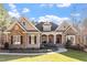 Charming home featuring stone and siding exterior, complemented by a well-manicured front yard and inviting entrance at 10014 Hammock Bend Bnd, Chapel Hill, NC 27517