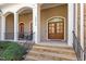 Inviting front porch featuring stone steps, decorative columns, and a double door entrance for a warm welcome at 10014 Hammock Bend Bnd, Chapel Hill, NC 27517
