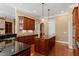 Well-appointed kitchen featuring a center island with a granite countertop and custom wood cabinets at 10014 Hammock Bend Bnd, Chapel Hill, NC 27517