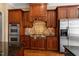 Modern kitchen with stainless steel appliances, custom wood cabinetry and granite countertops at 10014 Hammock Bend Bnd, Chapel Hill, NC 27517
