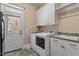 Laundry room with washer, dryer, sink and direct access to the outside at 10014 Hammock Bend Bnd, Chapel Hill, NC 27517