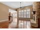 Spacious living room with hardwood floors, stone fireplace, wet bar, and large windows providing ample natural light at 10014 Hammock Bend Bnd, Chapel Hill, NC 27517
