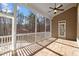 Inviting screened porch with stone-look tile flooring, wood ceiling, and ceiling fan at 10014 Hammock Bend Bnd, Chapel Hill, NC 27517