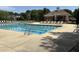 A large community pool with clear water and ample lounge chairs, perfect for relaxation and recreation at 10014 Hammock Bend Bnd, Chapel Hill, NC 27517