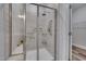 Modern bathroom with a glass-enclosed shower, neutral tile, and safety bars at 1012 Seedling Ct, Durham, NC 27703