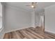 Bedroom featuring wood-look floors, ceiling fan, and neutral wall color with connecting doors at 1012 Seedling Ct, Durham, NC 27703