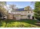 Large backyard featuring lawn and the rear of the home and screened in porch at 102 Calm Winds Ct, Cary, NC 27513