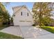 Attached two-car garage with long driveway and a well-manicured lawn at 102 Calm Winds Ct, Cary, NC 27513