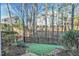 A backyard is thoughtfully designed with artificial turf and a metal fence at 103 Hundred Oaks Ln, Holly Springs, NC 27540