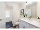 Cozy, well-lit bathroom with white shaker cabinets and decorative wall art at 106 N Trail Dr, Raleigh, NC 27615