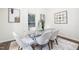 Bright dining room featuring a modern glass table, plush chairs, and stylish decor at 106 N Trail Dr, Raleigh, NC 27615