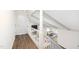 Bright hallway featuring wood floors, white wood trim, and views into the living room at 106 N Trail Dr, Raleigh, NC 27615