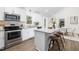 Modern kitchen with stainless steel appliances, white cabinets, and a kitchen island at 106 N Trail Dr, Raleigh, NC 27615