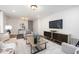 Bright living room featuring neutral furniture, large windows, and wood flooring at 106 N Trail Dr, Raleigh, NC 27615