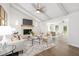 Open living room showcasing a brick fireplace, vaulted ceiling and seamless flow to other living areas at 106 N Trail Dr, Raleigh, NC 27615
