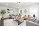 Bright living room featuring neutral furniture, large windows, and wood flooring at 106 N Trail Dr, Raleigh, NC 27615